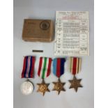 A set of four World War II medals, 1939-45 War medal, Italy Star, Africa Star, 1939-45 Star, and a