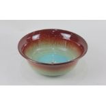 A Royal Lancastrian red and turquoise glazed bowl, impressed marks and numbered 213 to base, 23.