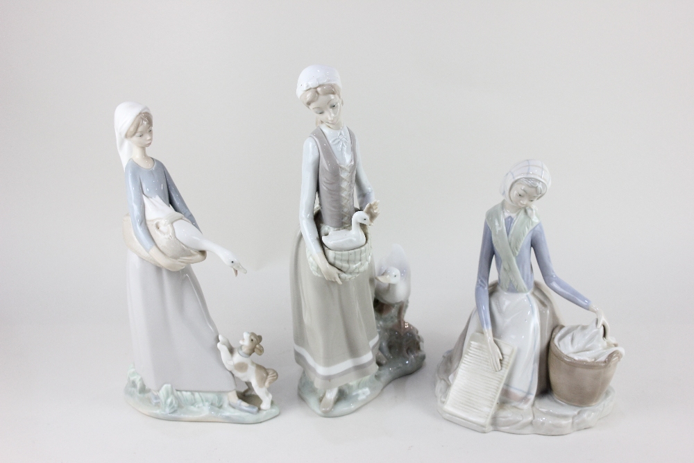 Two Lladro porcelain figures of ladies with geese, tallest 26cm high, together with a Lladro style