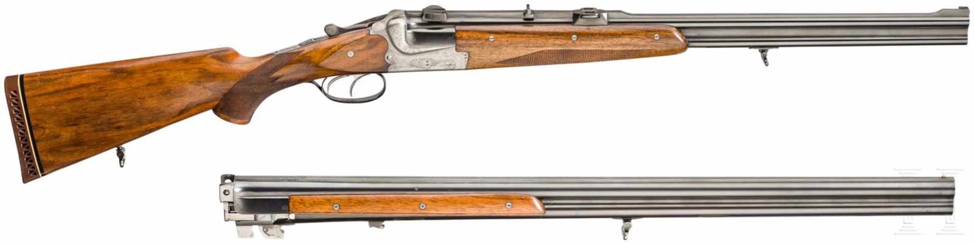 A cased double-barrelled over-and-under rifle by Hambrusch with three extra barrels