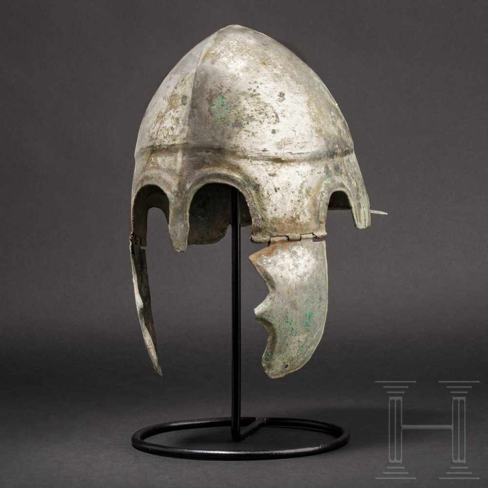 A Chalcidian helmet, type V, early 4th century B.C.Bronze helmet with full-faced tin plating with