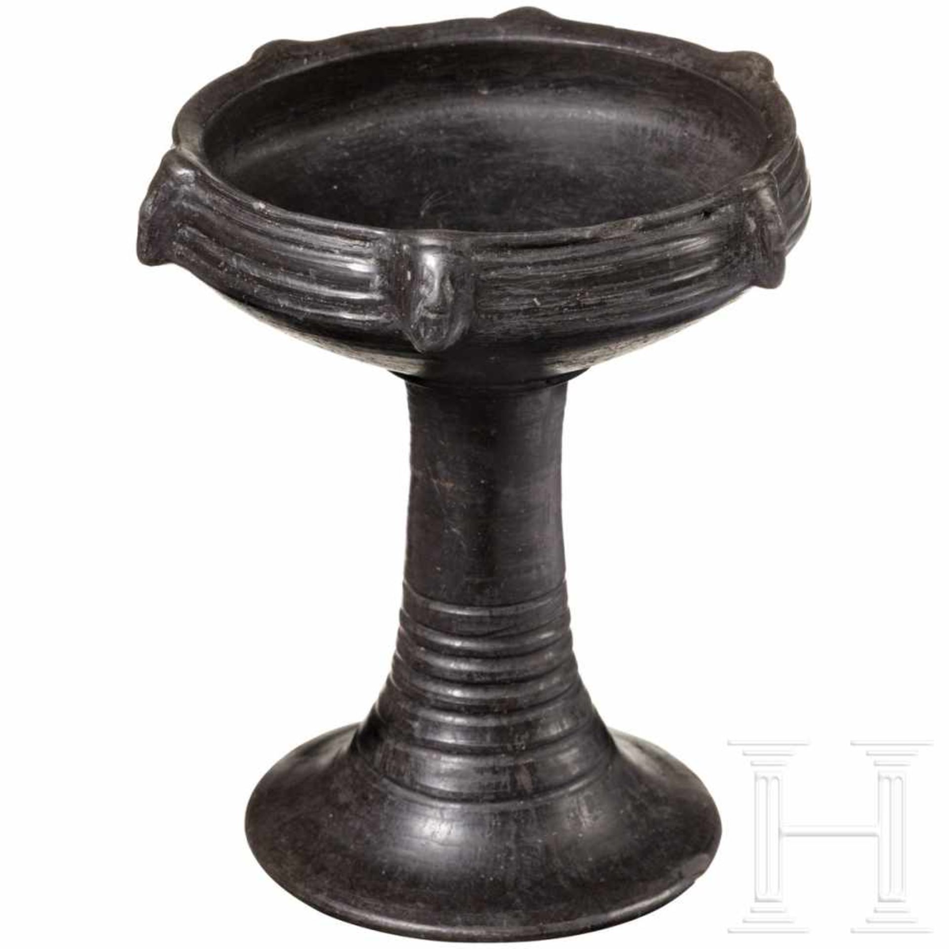 An Etruscan bucchero goblet with plastic masks, 550 - 540 B.C.Black bucchero ware chalice with a - Bild 2 aus 3