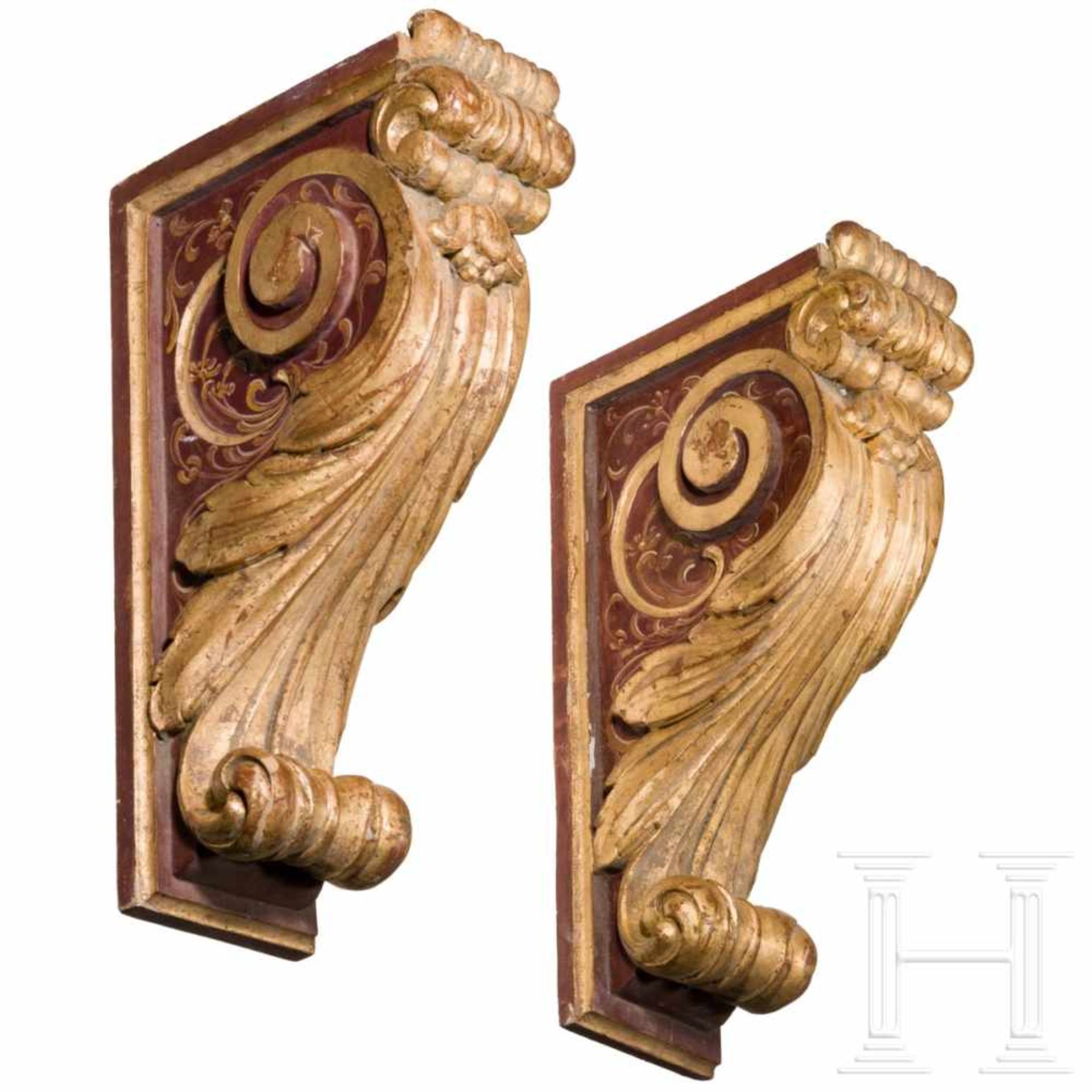 A pair of carved, painted and partly gilded southern German wall consoles in the style of the