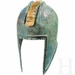 An Illyrian helmet, 5th century B.C.The hemispherical, hammered helmet skull with two raised,
