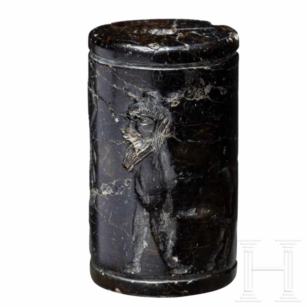 A Near Eastern Cylindric Seal, 2nd millennium B.C.A carved cylinder seal with mythological scene. - Image 2 of 5