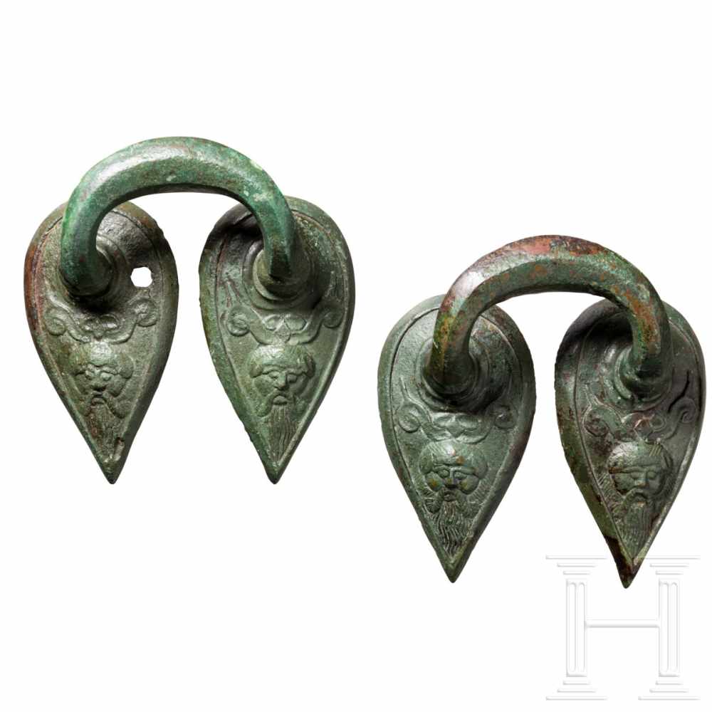 Two late archaic Greek handles, bronze, circa 500 B.C.Two bronze handles probably of a hydria with a
