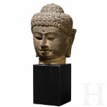 A large Javanese Buddha head carved in volcanic rock, 9th centuryThe fully sculptured, life-sized