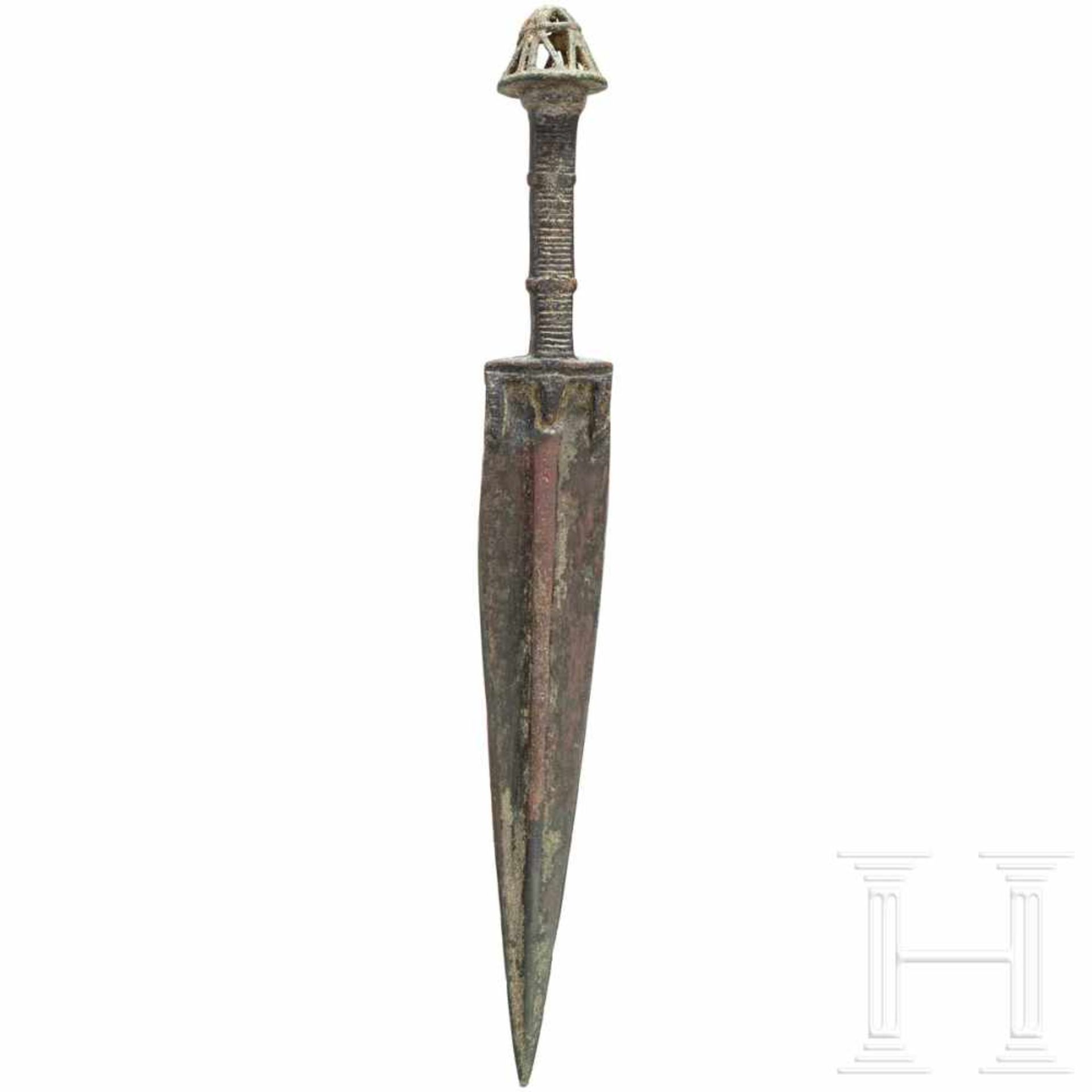 A Luristan bronze dagger, late 2nd - early 1st millenium B.C.Blade with wide central ridge. The hilt