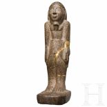 An Egyptian style granite figureMassive figure of a striding man. The figure appears stocky, hands