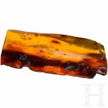 A large piece of amber with inclusionsGeschliffenes und poliertes Stück aus Bernstein mit mehreren