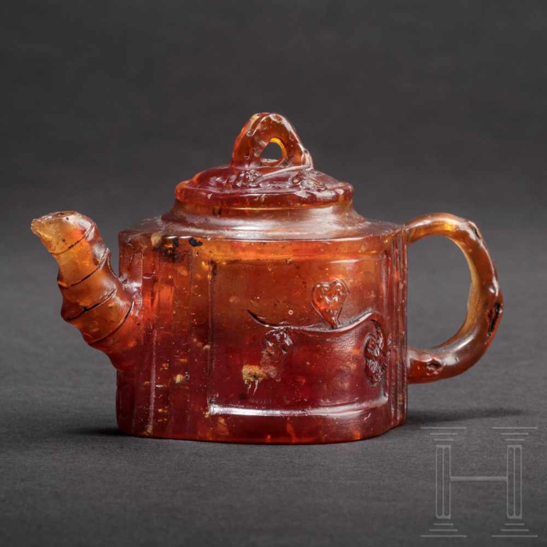 A rare miniature teapot in amber, Königsberg, circa 1700/20The two-part teapot carved in honey-