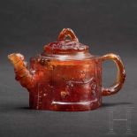 A rare miniature teapot in amber, Königsberg, circa 1700/20The two-part teapot carved in honey-