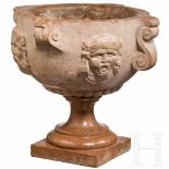 An Italian Baroque marble mortar with grotesque masks, 17th century, on a later baseReddish