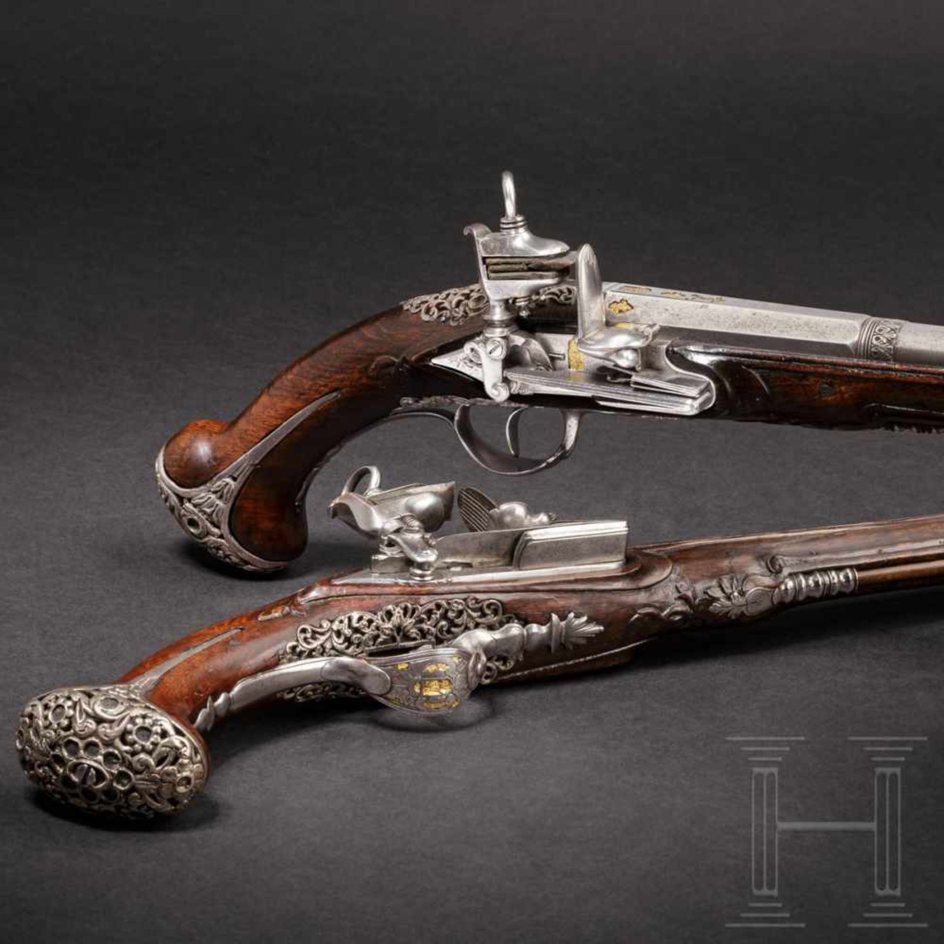 A pair of North Spanish, silver-mounted miquelet pistols, late 18th centuryOctagonal barrels turning