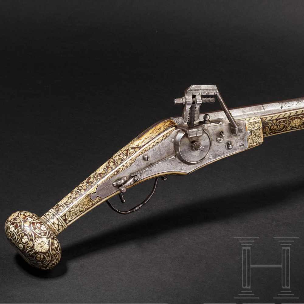 A German wheellock puffer, lavishly inlaid in bone, dated 1573The smooth octagonal barrel turning to