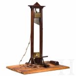 A French walnut, mahogany, iron and brass model of a guillotine, circa 1900Nussbaum, Mahagoni, Eisen