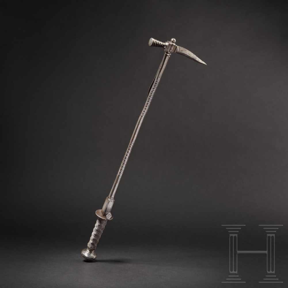 A long German war hammer with faceted decor, circa 1600Slender, slightly curved, rectangular beak.