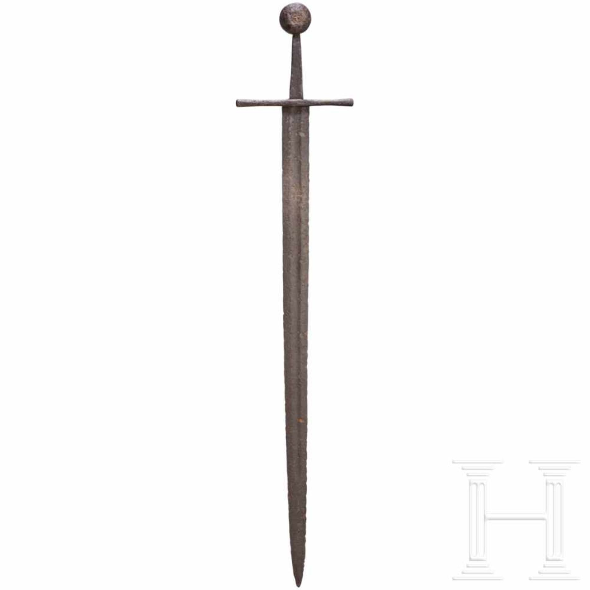 A German sword with disc pommel, circa 1300Sturdy, double-edged blade with long fuller on either