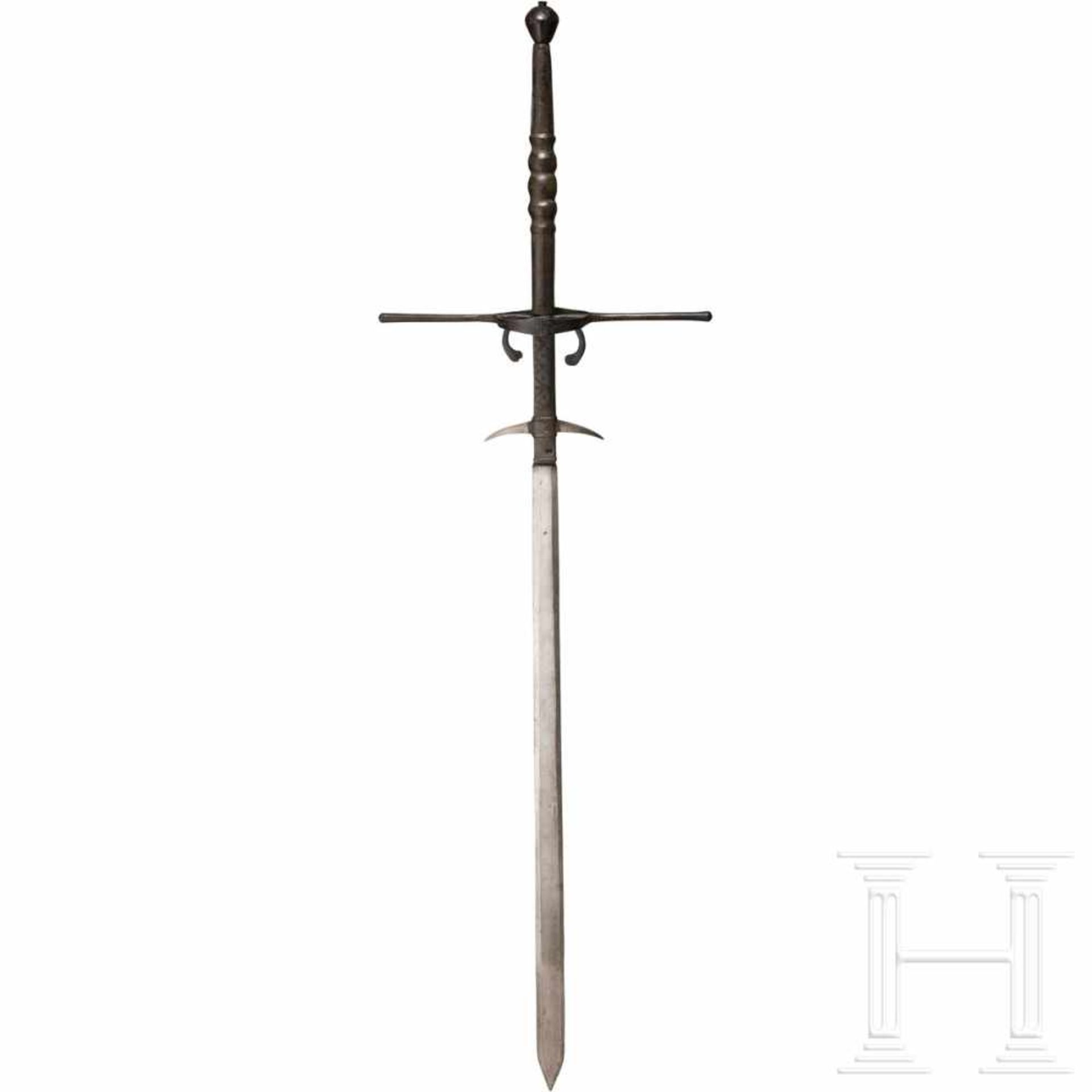 A significant South German two-handed sword, circa 1580The double-edged, conical blade widening