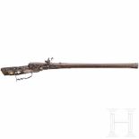 A southern German carved wheellock rifle with mother-of-pearl inlays in the style of the Maucher