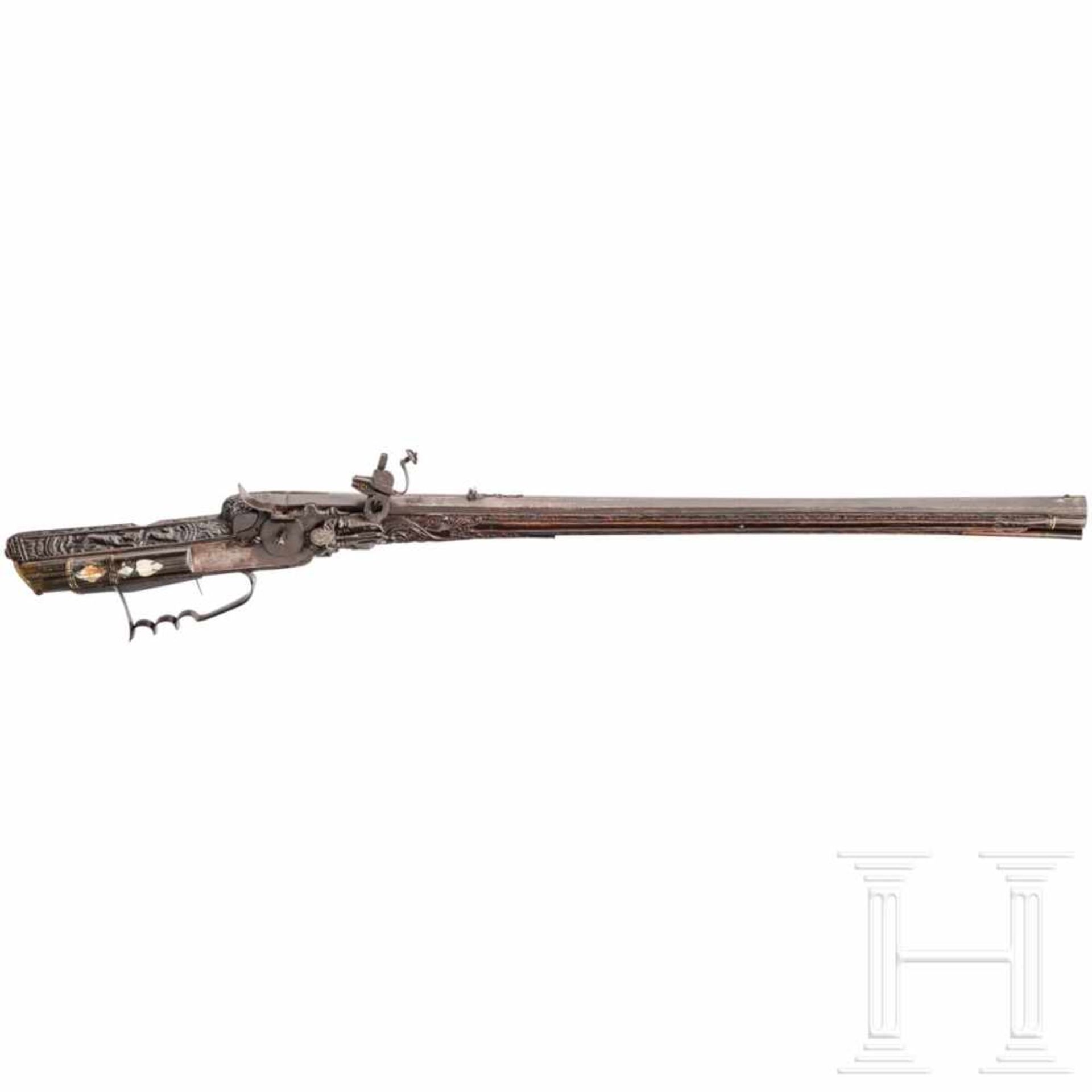 A southern German carved wheellock rifle with mother-of-pearl inlays in the style of the Maucher