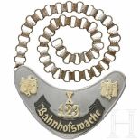 A "Bahnhofswache" gorgetThe shield lacquered in silver with a riveted grey banner inscribed "