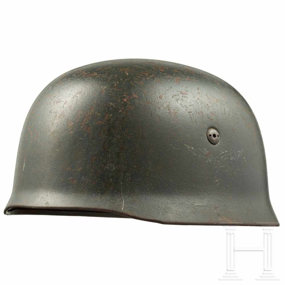 An M 38 steel helmet for paratroopersThe skull stamped "ET68" and "1849"(?). Early two-hole screws