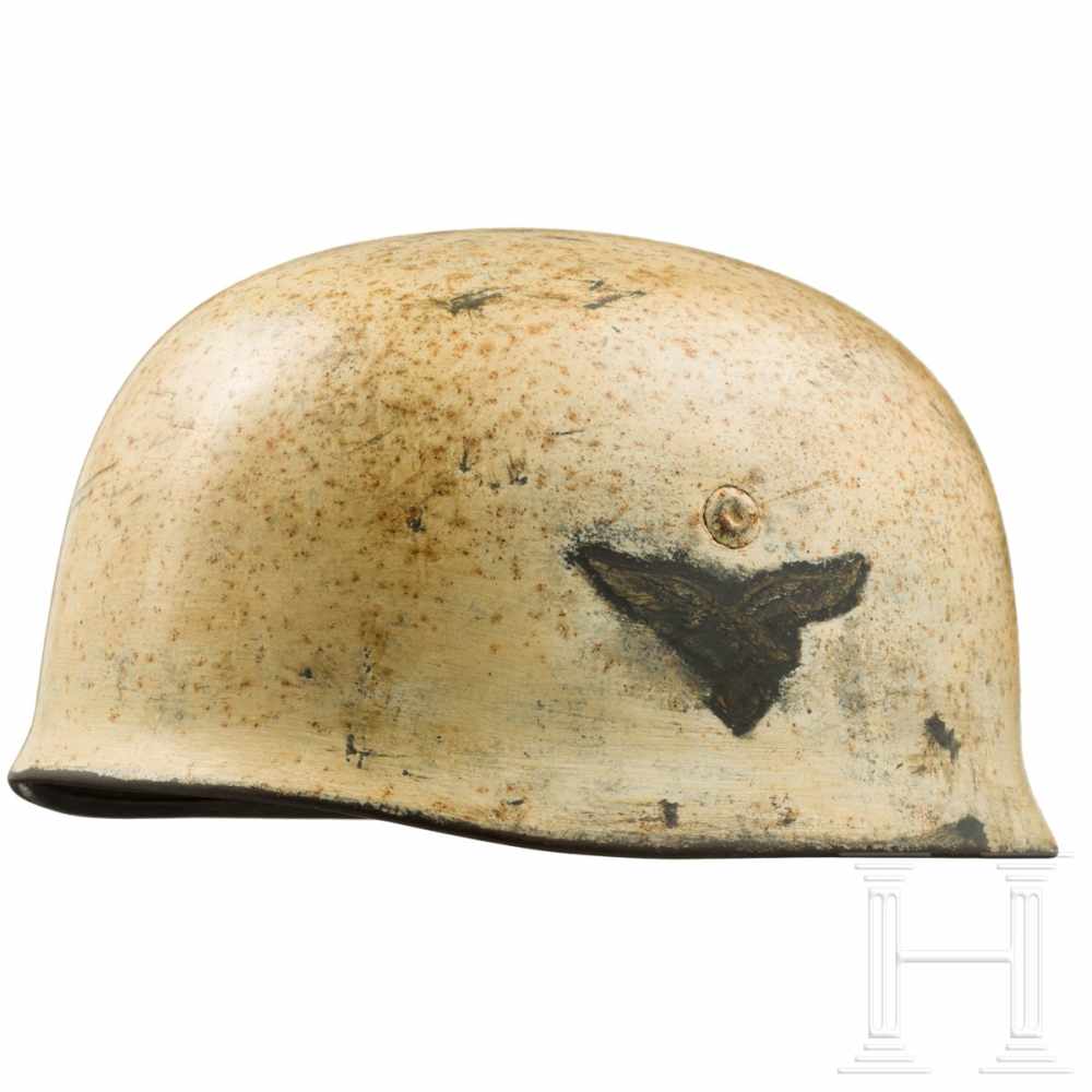 An M 38 steel helmet for paratroopers with winter camouflage paintThe skull with white camouflage