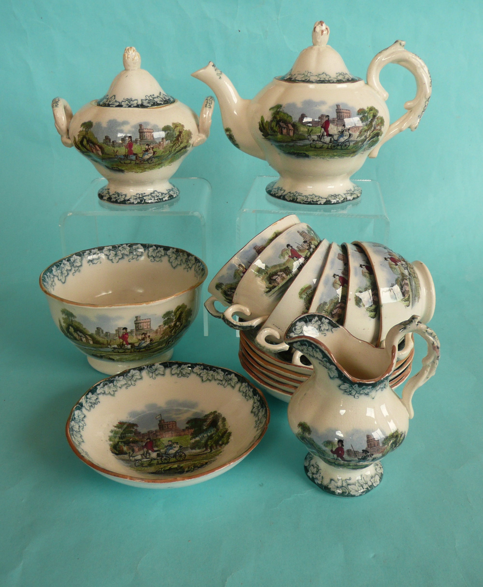 A child’s tea set comprising teapot, spout restored, 118mm, a sucrier, a jug,