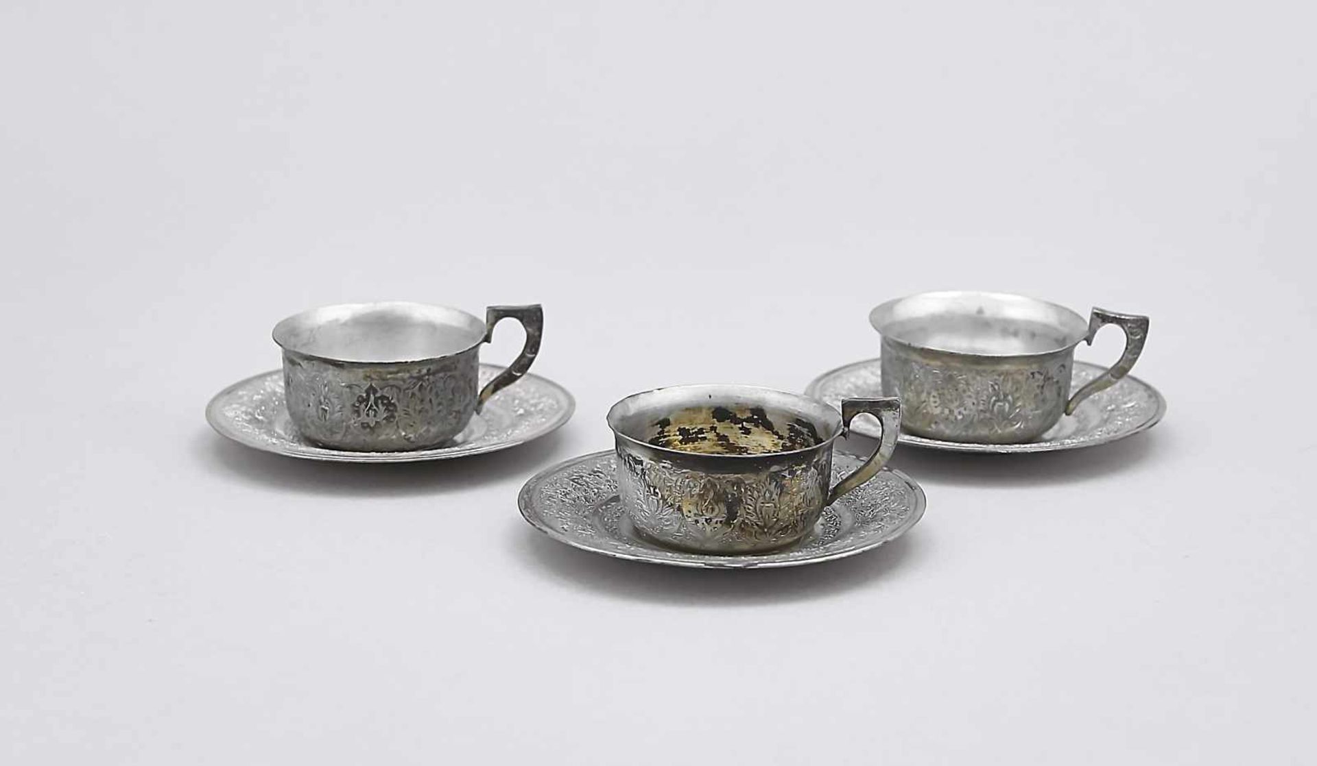 Three mocha cups with saucers, probably Persia, 20th century, plated, with floral