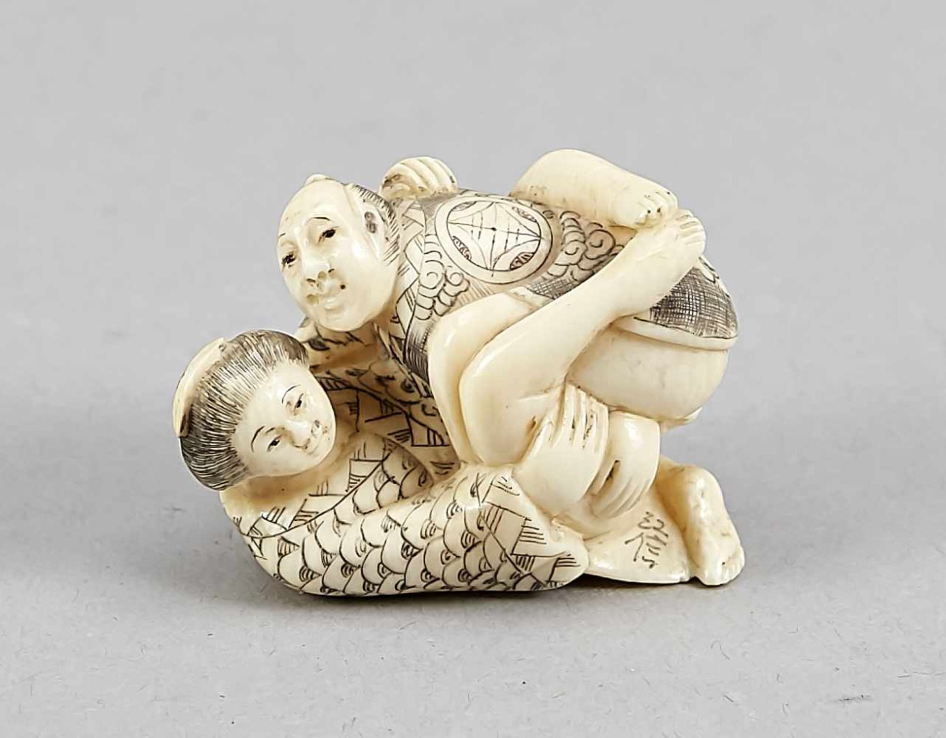 A Japanese shunga netsuke around 1900, ivory carved in the round, incised decor in