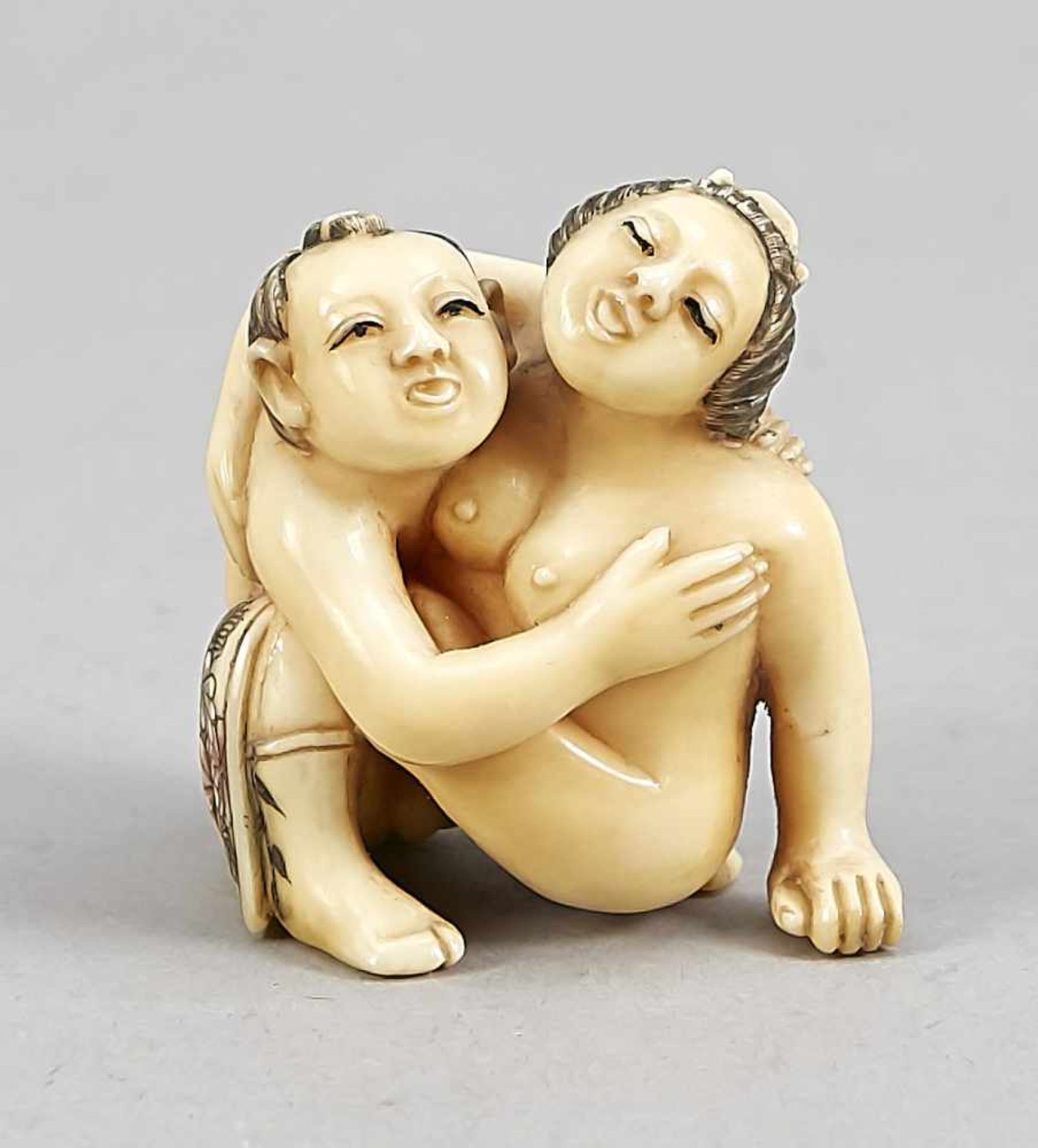 A Japanese shunga figure around 1900, ivory carved in the round, incised decor in colours,