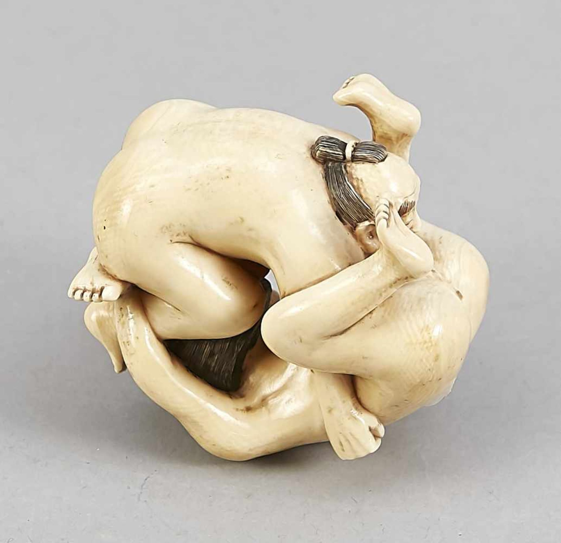 A Japanese shunga figure around 1900, ivory carved in the round, the underside signed,