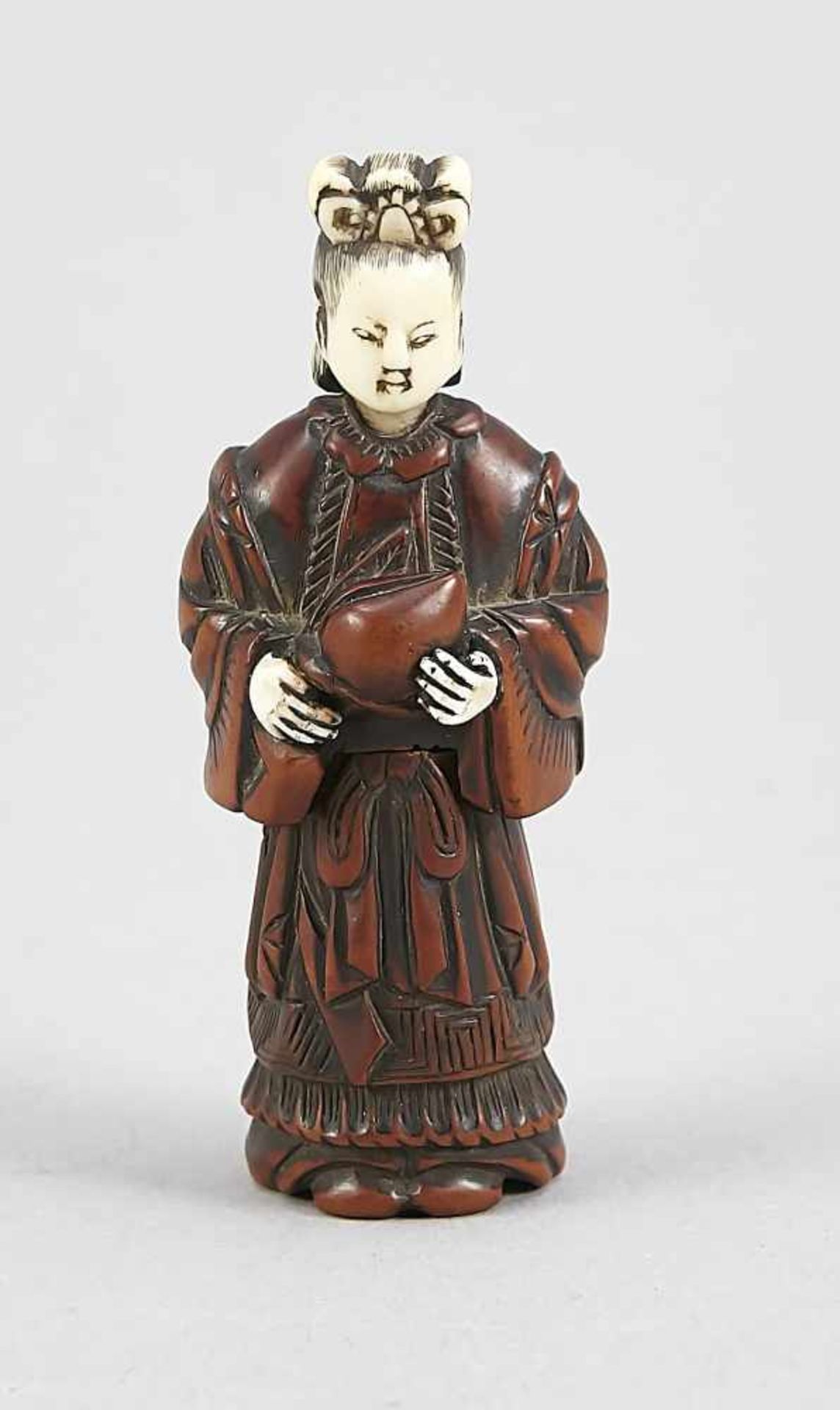 A Japanese shunga geisha(?) figure holding a peach, around 1900, boxtree and bone carved