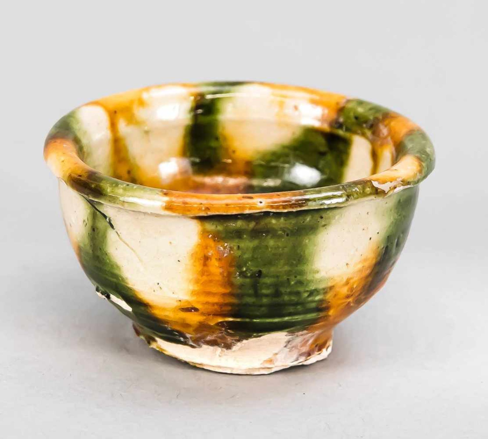 Small wine cup with Sancai glaze, China, Tang Dynasty. Largely unglazed foot, beaded edge,