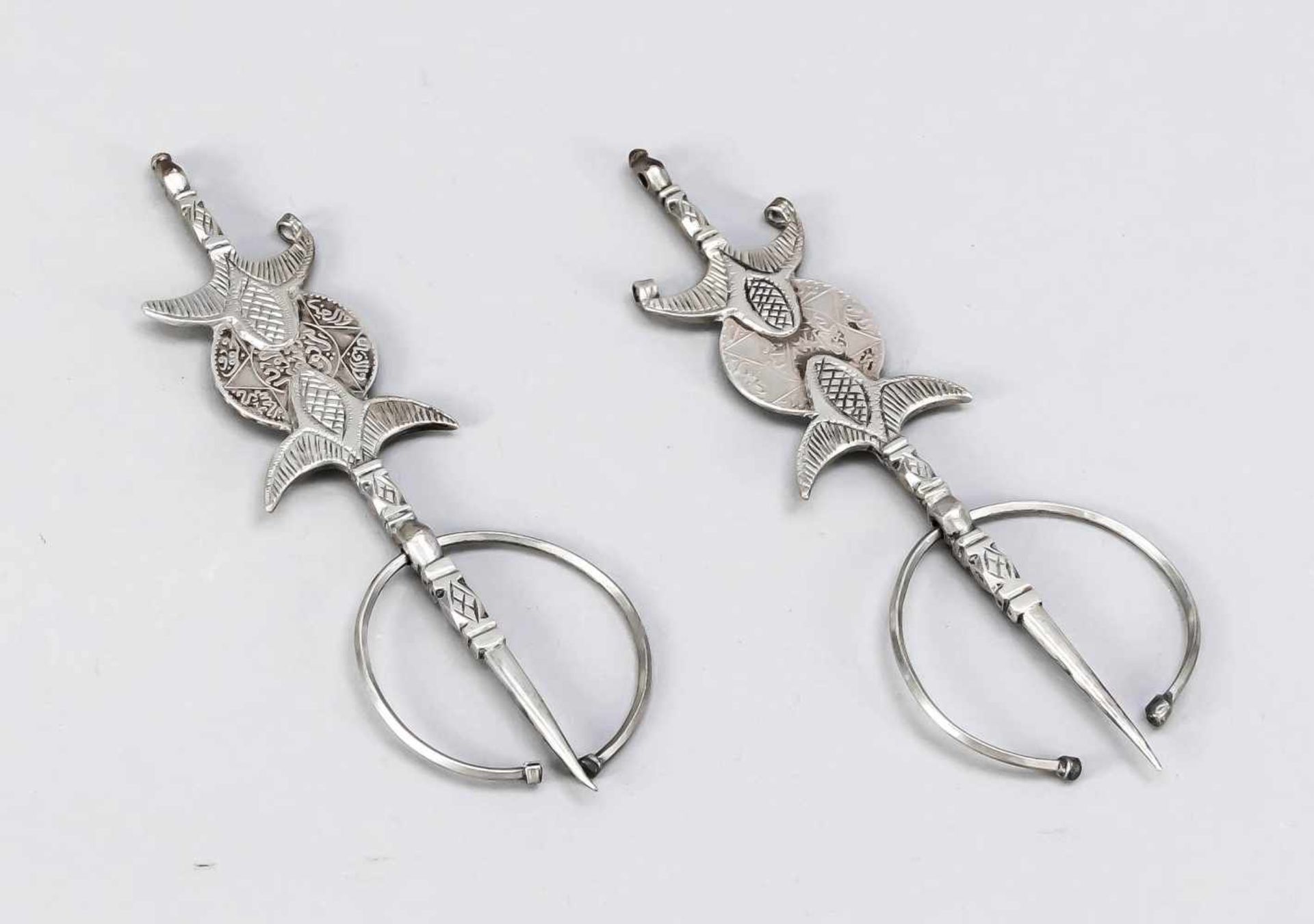 Pair of large fevers, Morocco, 1st third of the 20th century, silver. Bordered by 2 flower