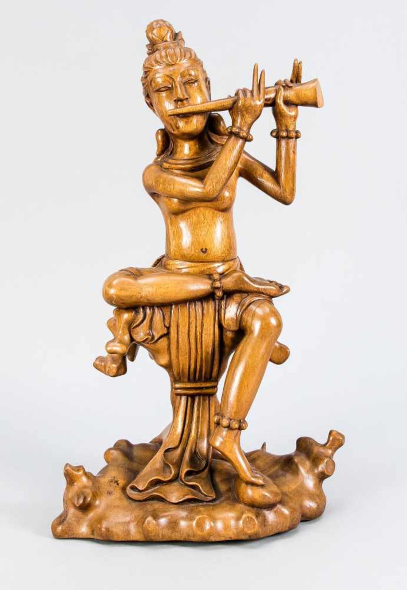 Yogi playing the flute on a floating cloth, probably India, 20th century, hardwood, h. 51