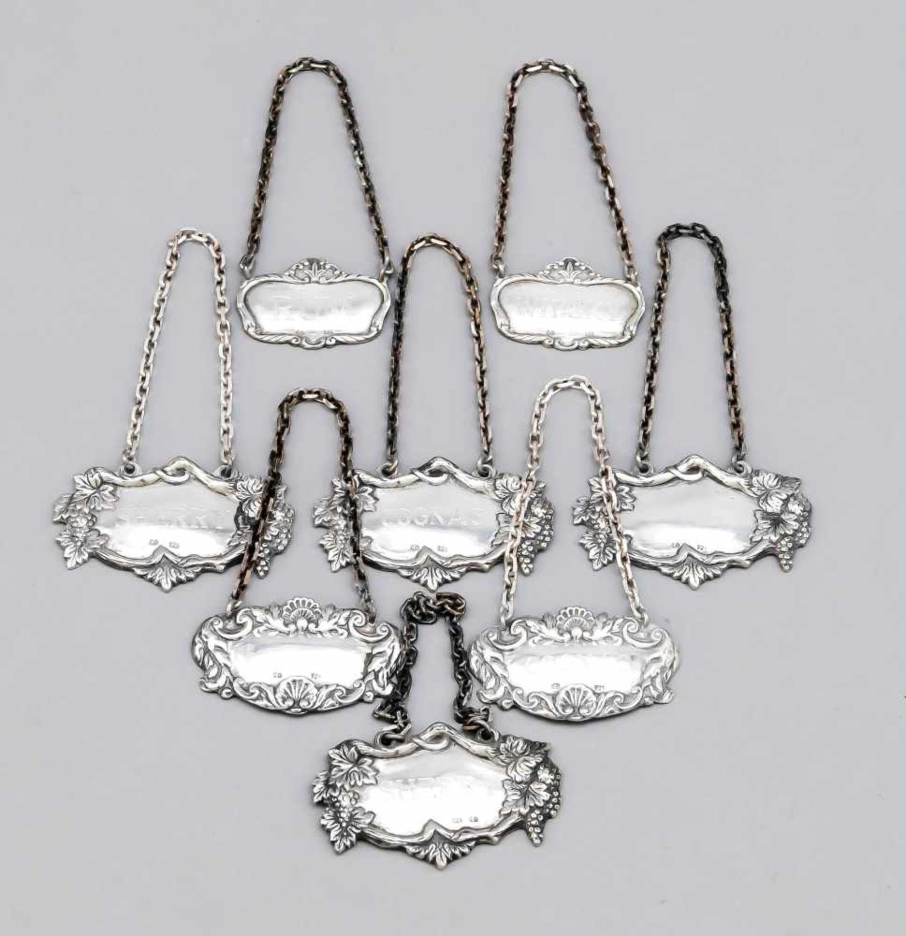 Eight bottle labels, German, 20th century, Sterling silver 925/000, different shapes and