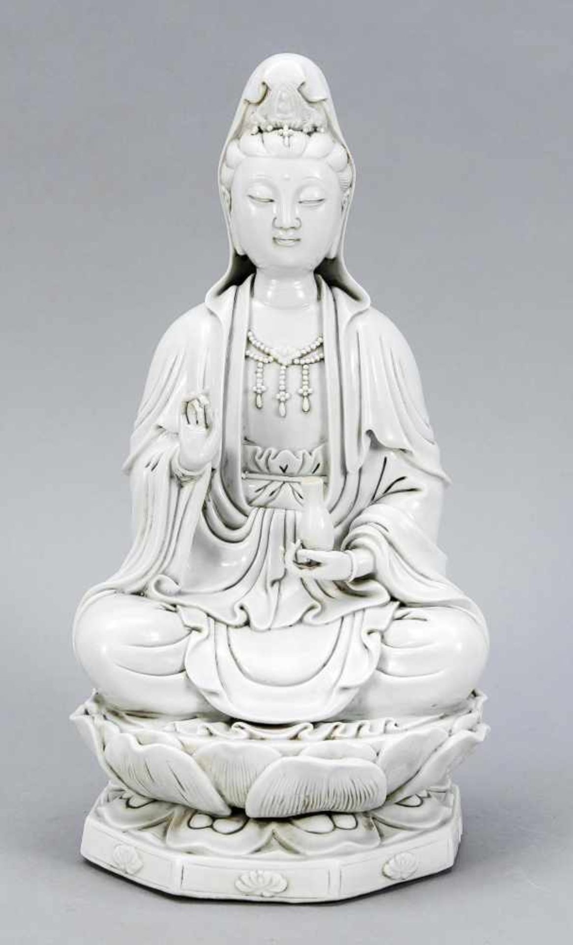 Blanc-de Chine-Guanyin, China, 19th / 20th Century Sitting on the octagonal lotus throne