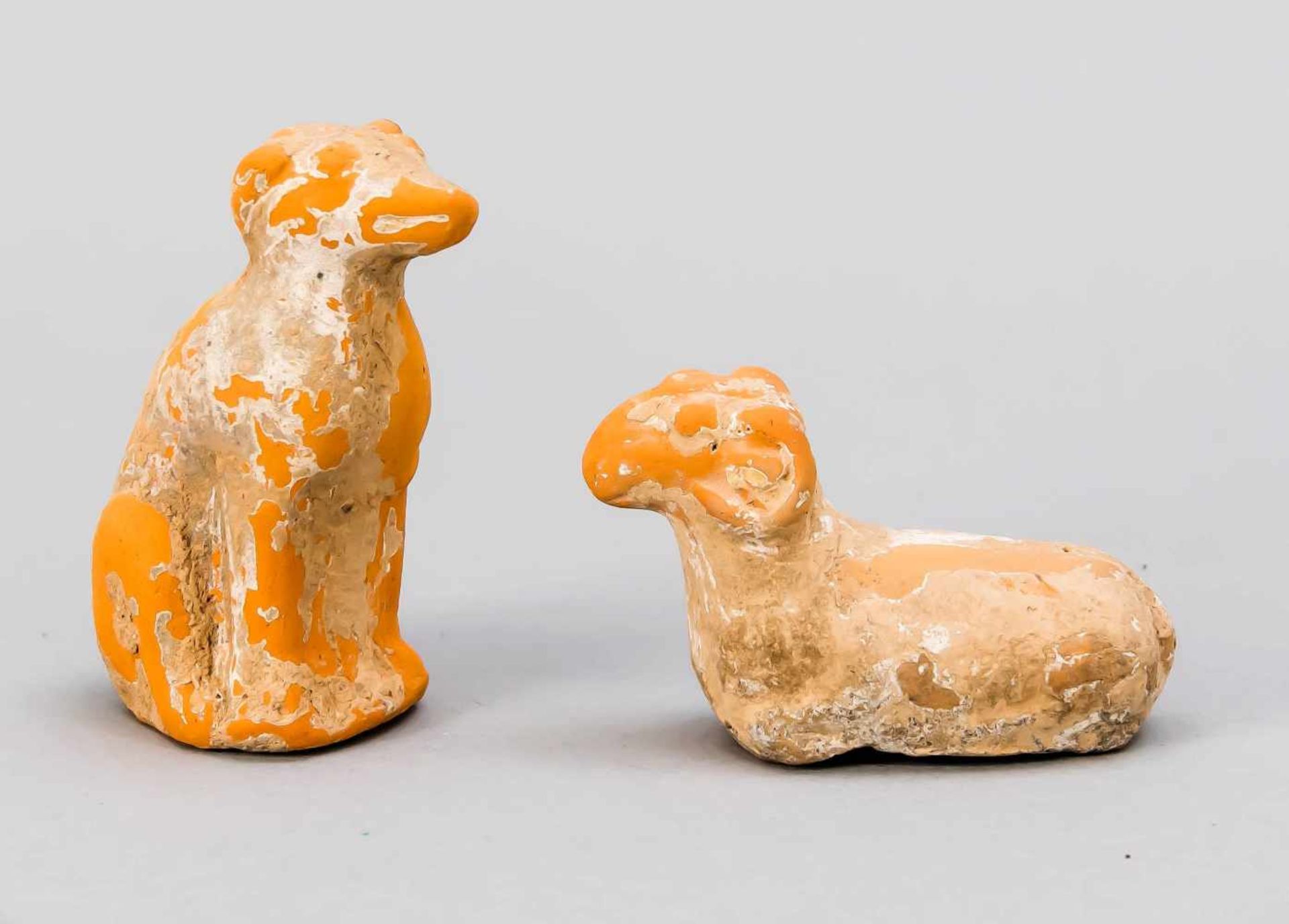 Sitting dog and ram, China, Tang Dynasty. Orange-brown ceramic with remains of earth, h.