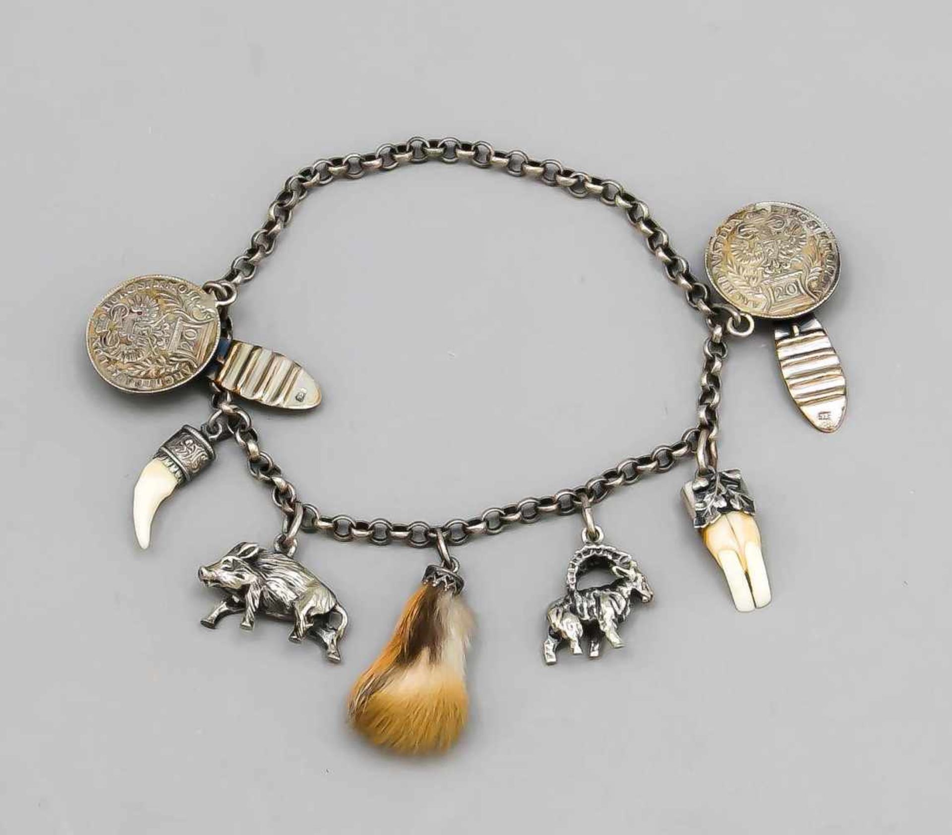 Charivari, early 20th century, silver 835/000, chain with various pendants, for examplecapricorn and
