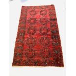 A DARK RED PATTERNED EASTERN RUG - APPROX 75 INCH X 45 INCH