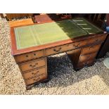 A REPRODUCTION TWIN PEDESTAL DESK WITH TOOLED GREEN LEATHER INSERT TO TOP