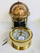 DESK GLOBE IN A BRASS FINISHED STAND ALONG WITH A BRASS CASED CLOCK WITH DETAILS OF DIFFERENT