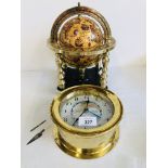 DESK GLOBE IN A BRASS FINISHED STAND ALONG WITH A BRASS CASED CLOCK WITH DETAILS OF DIFFERENT