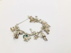 A SILVER CHARM BRACELET WITH 18 CHARMS ATTACHED