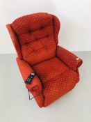 AN ELECTRIC RECLINING ARMCHAIR UPHOLSTERED IN A DEEP RED FABRIC - SOLD AS SEEN