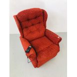 AN ELECTRIC RECLINING ARMCHAIR UPHOLSTERED IN A DEEP RED FABRIC - SOLD AS SEEN