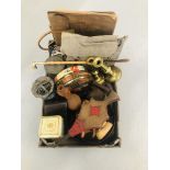 A BOX OF COLLECTIBLES TO INCLUDE VINTAGE TINS, IRONS, BELLOWS, A PAIR OF BRASS CANDLESTICKS,