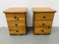 A PAIR OF HONEY PINE THREE DRAWER BEDSIDE CHESTS